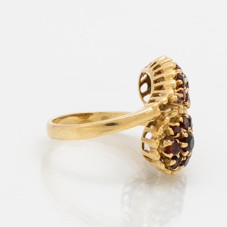 An 18K gold ring with garnets.