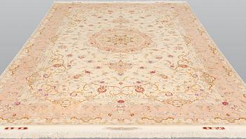 A Tabriz part silk carpet, signed, 305 x 203 cm.