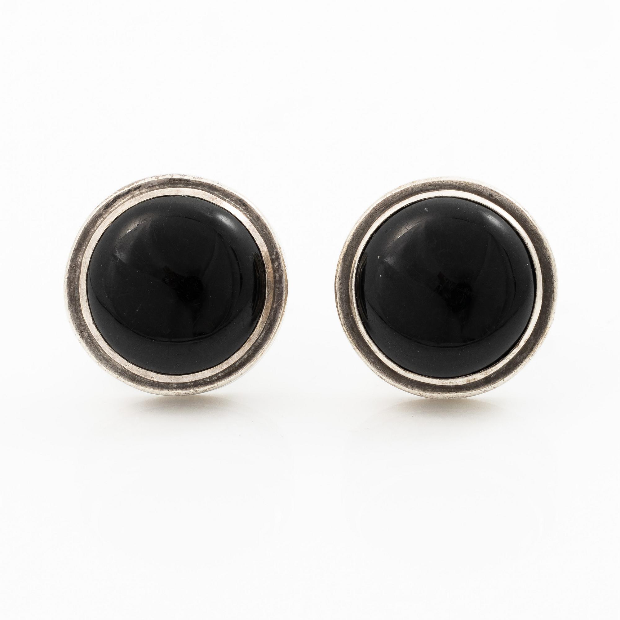 Cufflinks, a pair in silver with cabochon-cut stones.