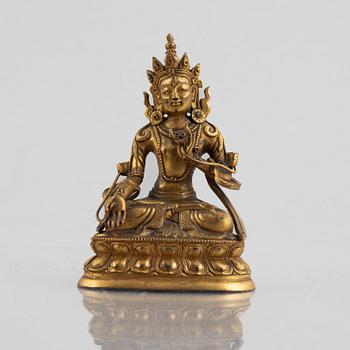 A gilt copper figure of a Buddha, 20th century.