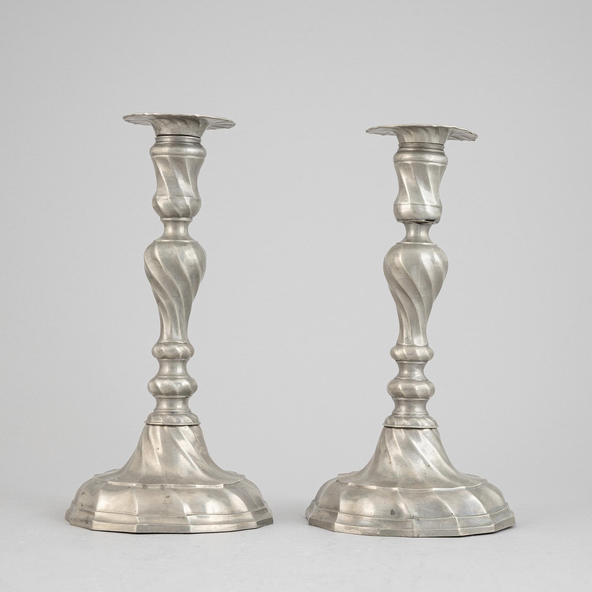 A pair of rococo style pewter candlesticks, 19th Century.