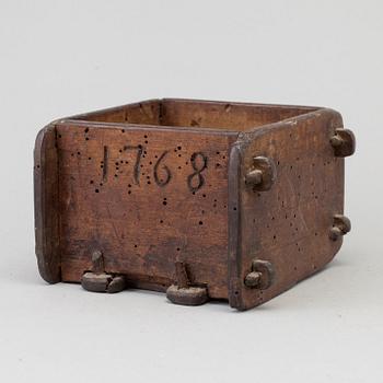 A cheese mould, dated 1768.