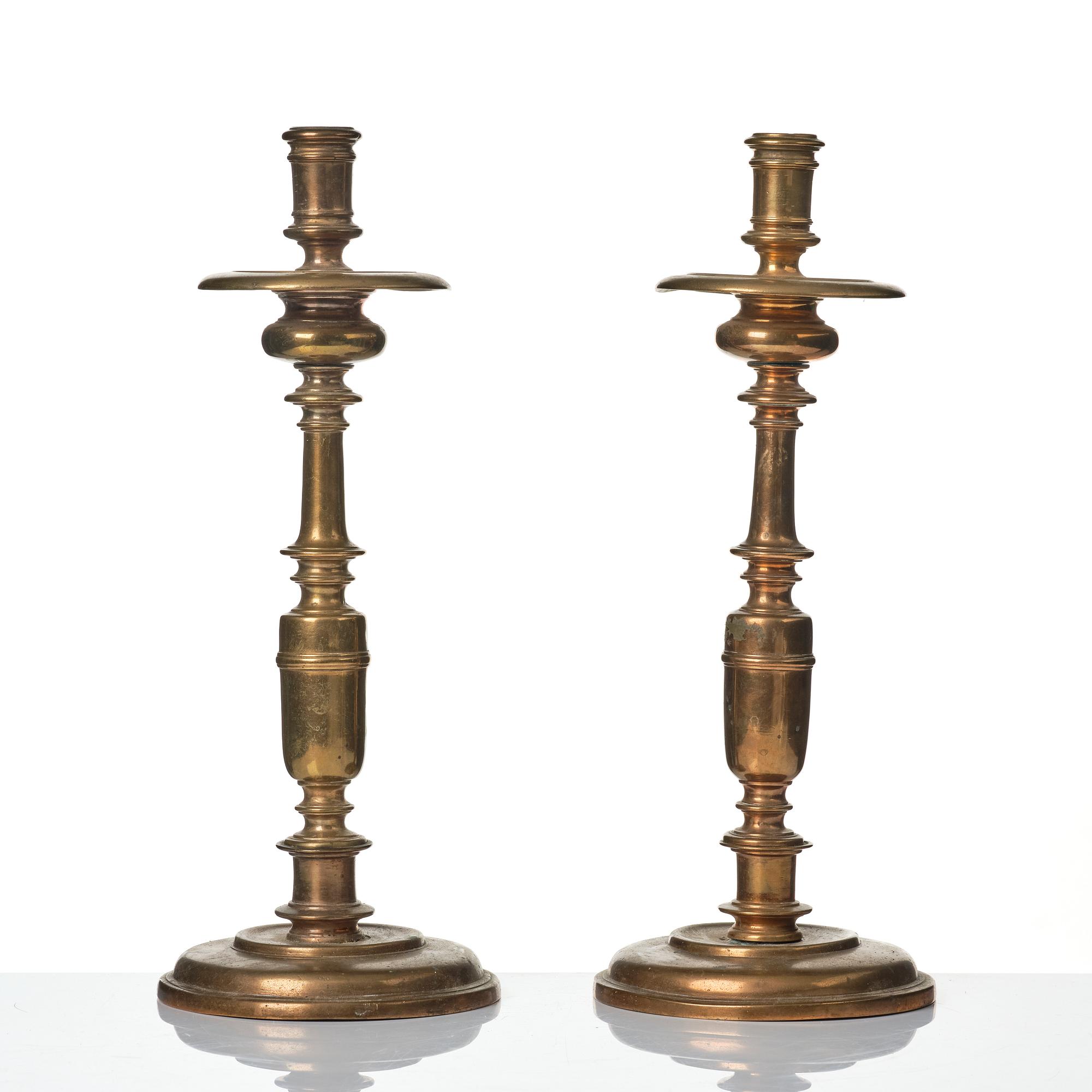 A pair of baroque brass candlesticks, 18th century.