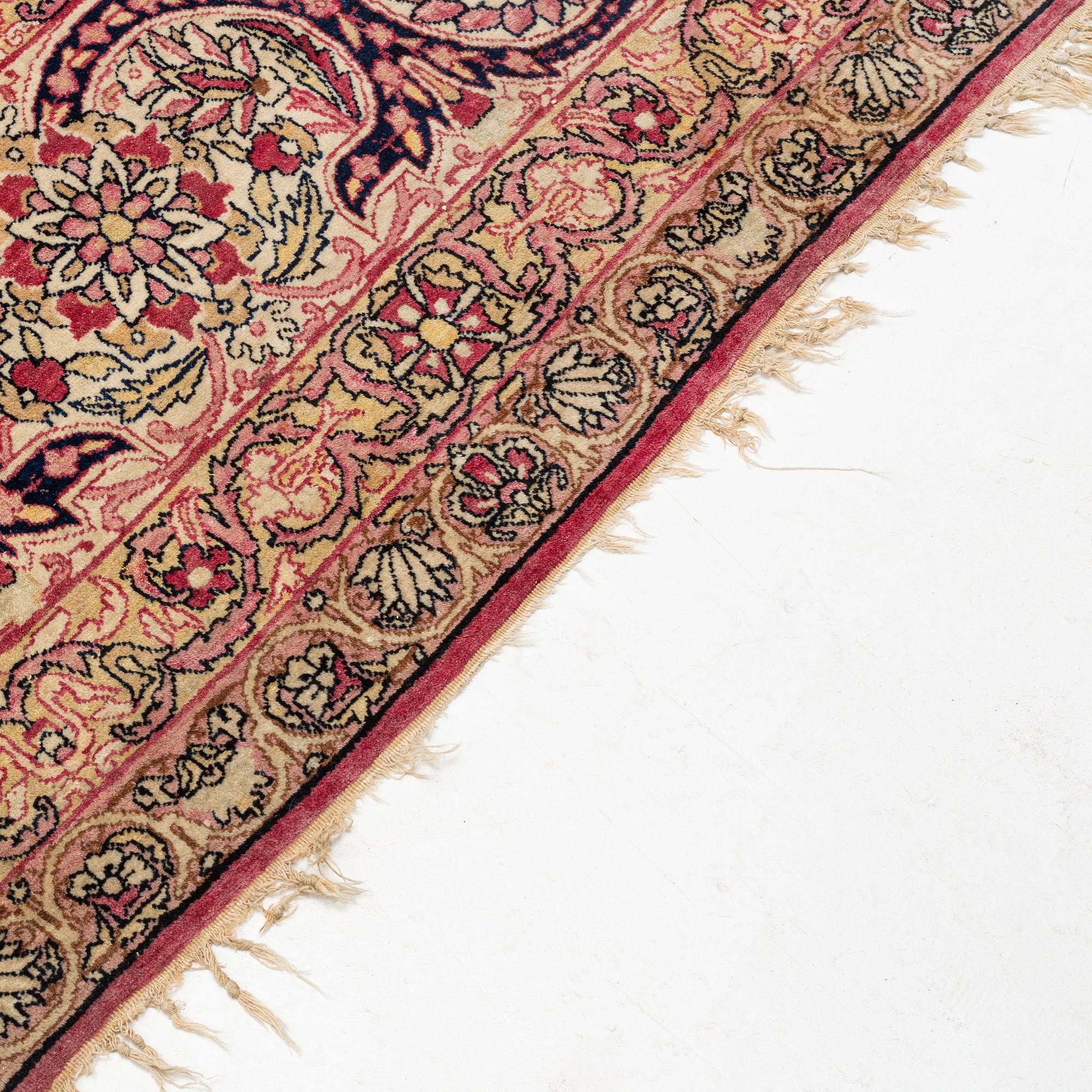 An antique Kerman Laver carpet, south east persia, ca 501 x 359 cm.