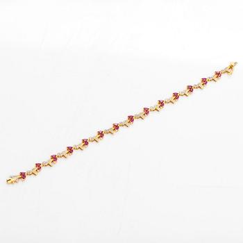 An 18K gold bracelet, with diamonds and rubies.