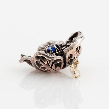 A silver and 14K gold brooch set with a blue stone and rose-cut diamonds.