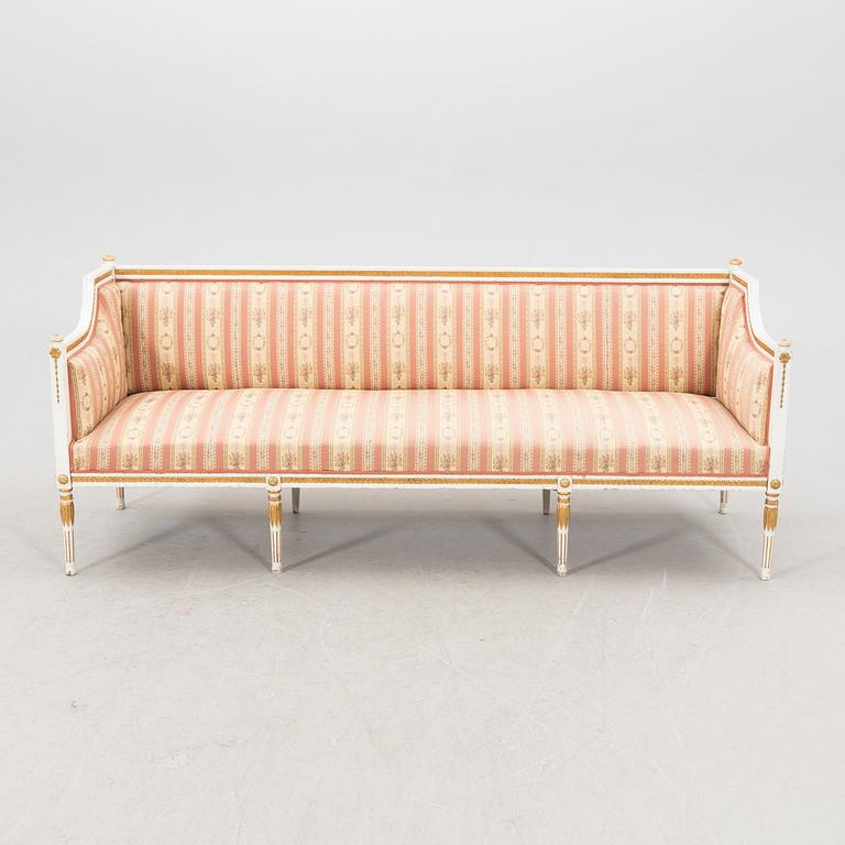 A painted and guilded late gustavian sofa from the 19th century.