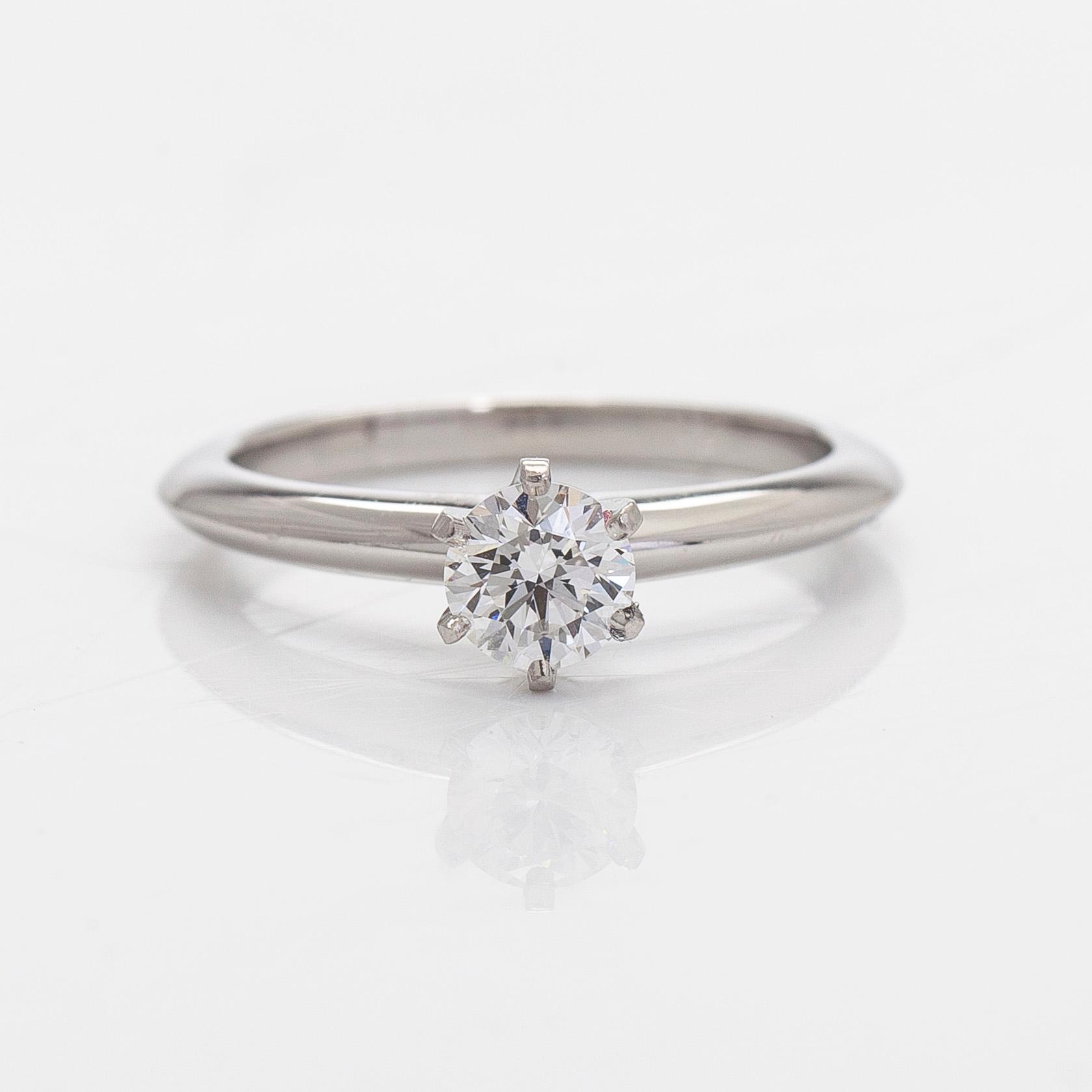 Tiffany & Co, a platinum solitaire ring with a brilliant-cut diamond.