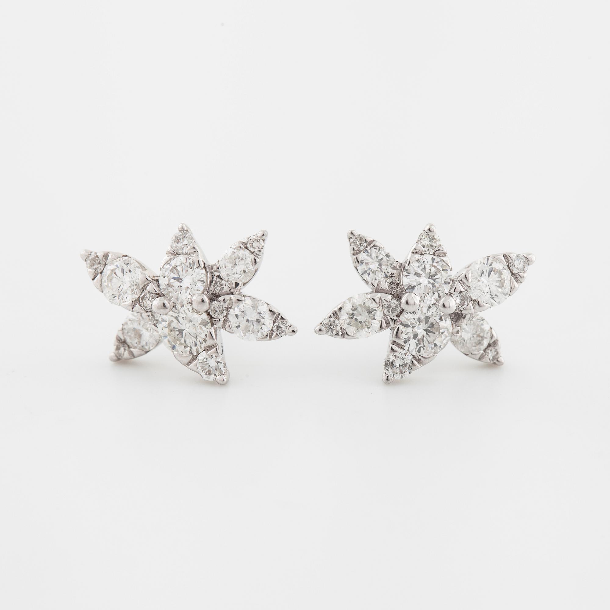 A pair of brilliant cut diamond earrings.