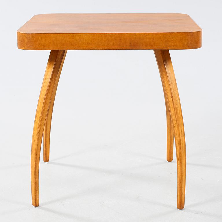 A table and a arm chair from the second quarter of the 20th century.