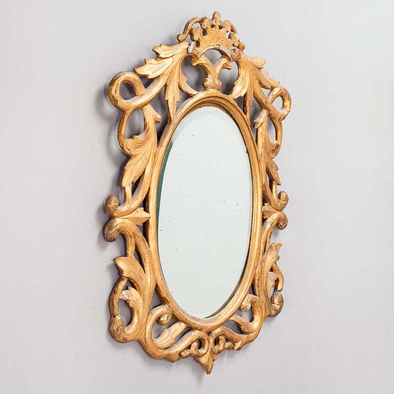 A gilded and bronzed woodcut leaf decorated mirror, second half of the 19th century.