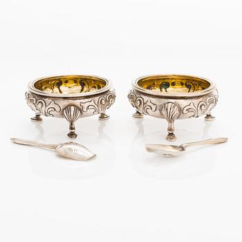 A set of 12 Russian silver salt cellars and 12 salt spoons, Sazikov 1860 & F. O. Fagerström 1850s-60s, Saint Petersburg.