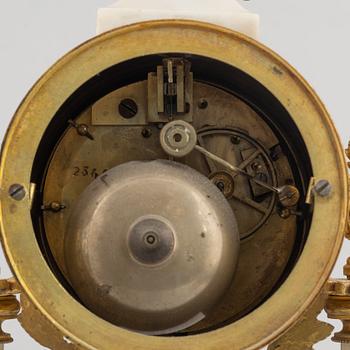 A Louis XVI-style mantel clock Paris, France and a pair of candelabras, late 19th century.