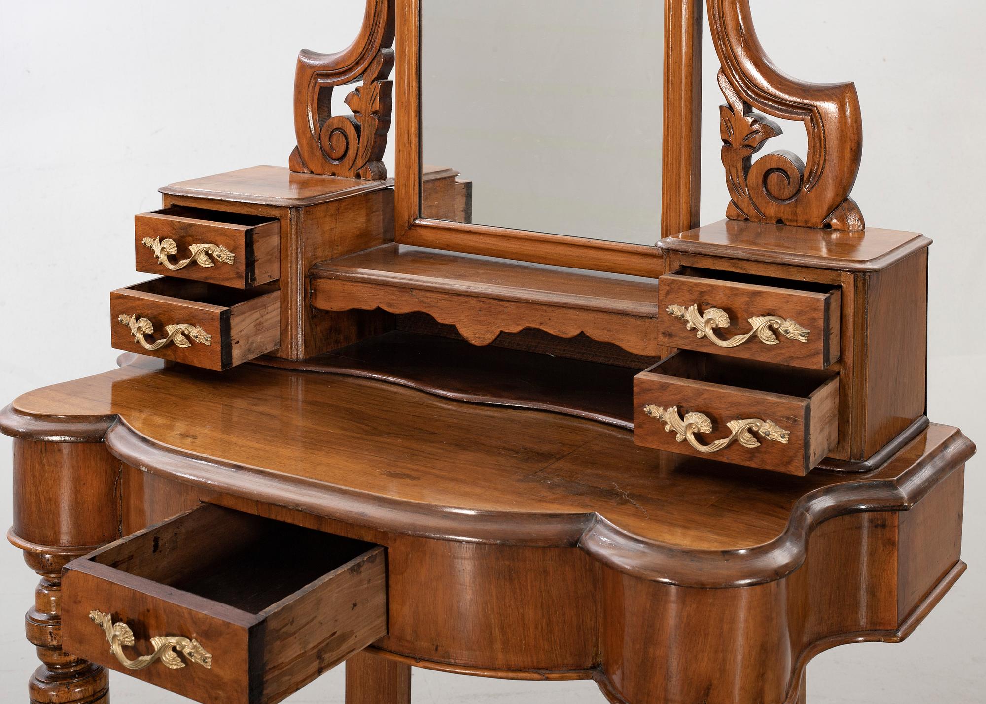 A second half of the 19th century table with mirror and a stool.