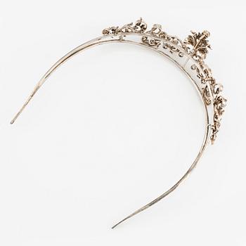 An 18K gold and silver tiara composed of scroll motifs set  with old- and rose-cut diamonds.