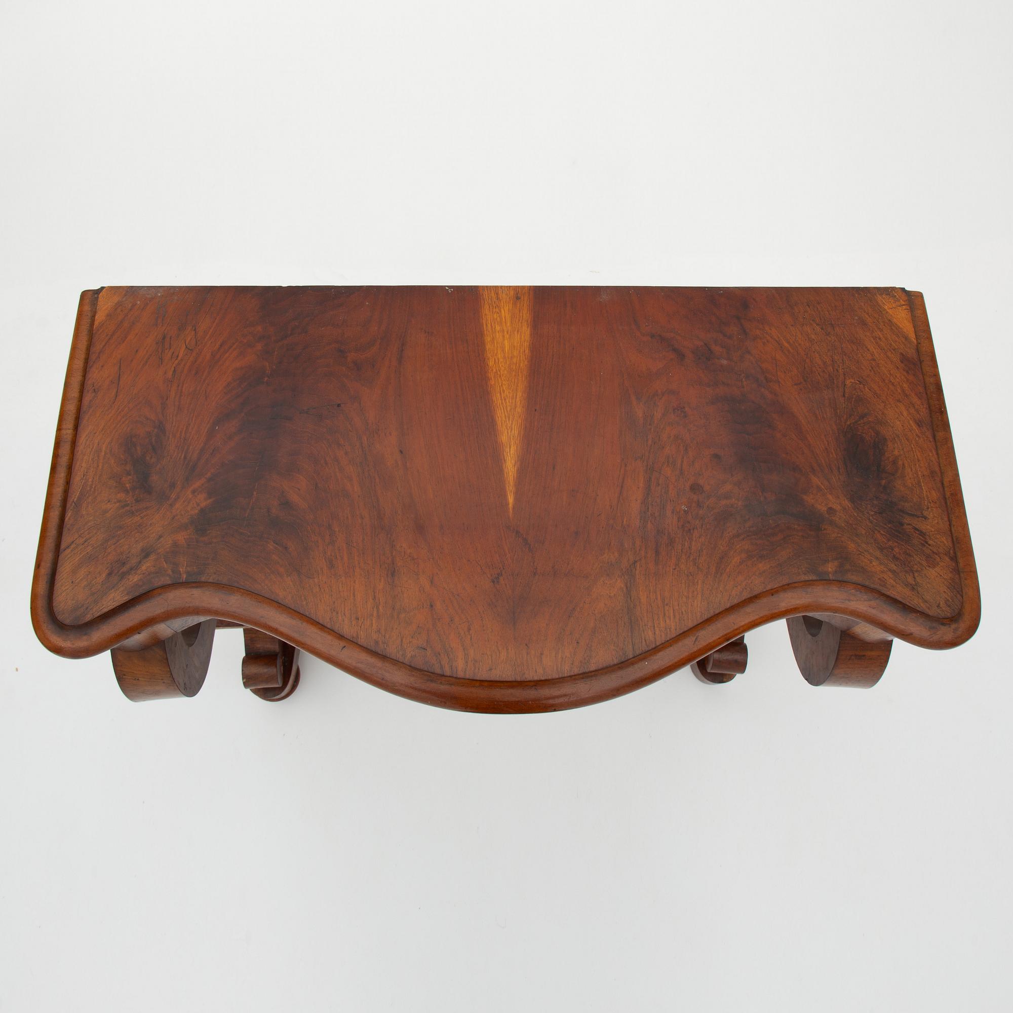 A Swedish Empire mirror with a console table, first half of the 19th Century.
