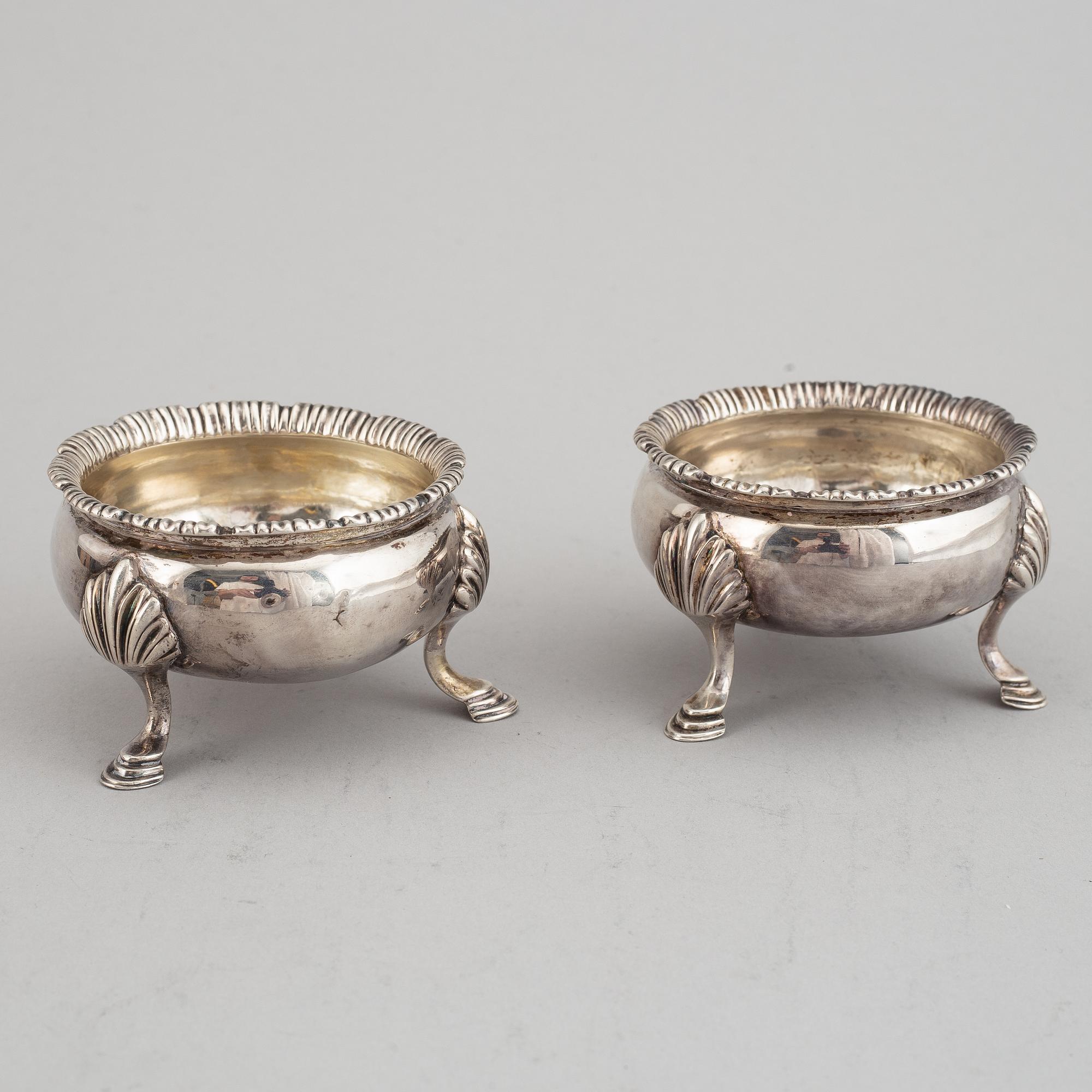 Two pairs of English 18th century silver salt-cellars, marked in London 1762 and 1769.