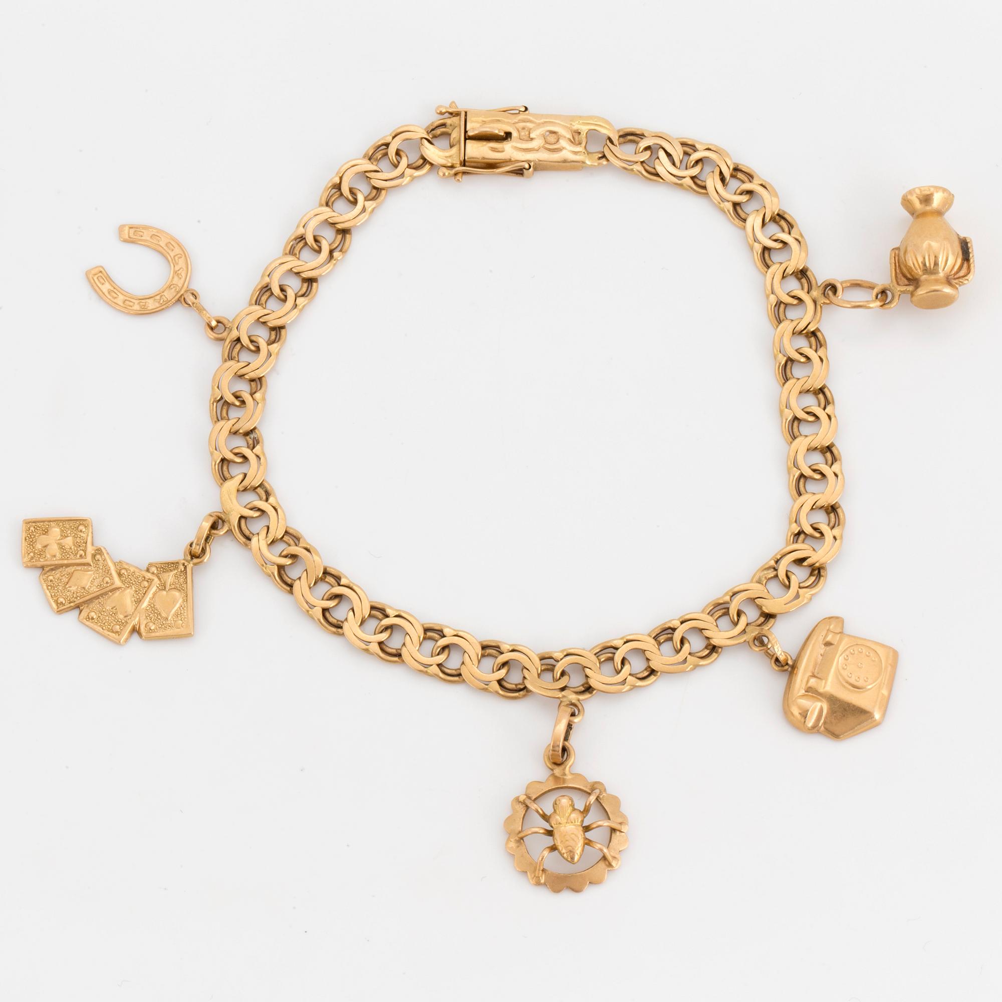 An 18K gold charm bracelet.