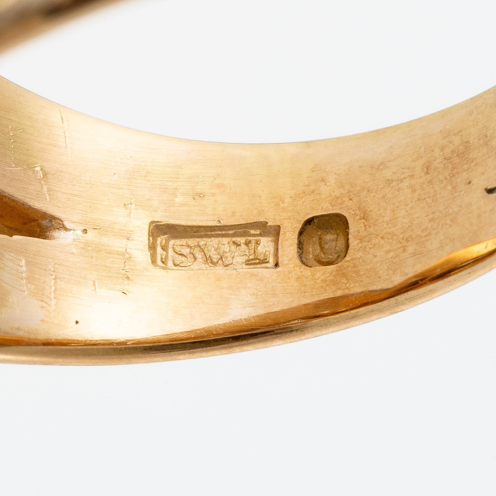 An 18K gold ring with cabochon-cut tourmalines.