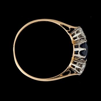 A facett cut sapphire ring set with brilliant cut diamonds.