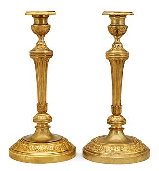 624. A pair of French Empire early 19th Century candlesticks.