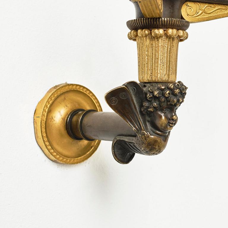 A pair of Empire patinated and ormolu two-branch appliques attr. to C. Galle (bronzier in Paris 1786-1815).