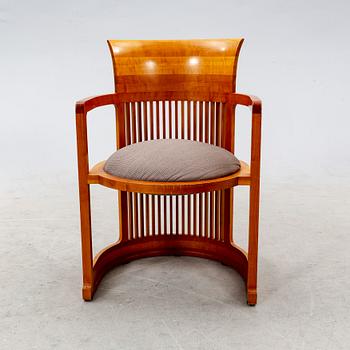 A cherry wood model 606 'Barrel' chair by Frank Lloyd Wright from Cassina.