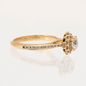 An 18K gold ring set with round brilliant-cut diamonds.