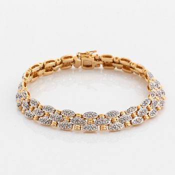 An 18K gold and white gold bracelet set with round brilliant-cut diamonds.