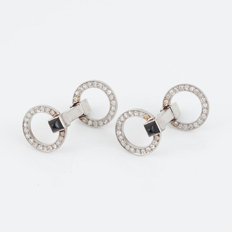 A pair of brilliant-cut diamond and onyx cufflinks.