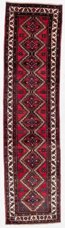 An oriental runner, c. 395 x 100 cm.