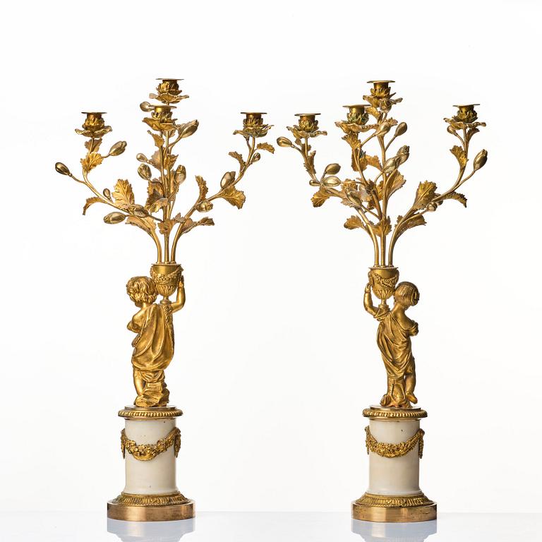 A pair of Louis XVI four light candelabra.