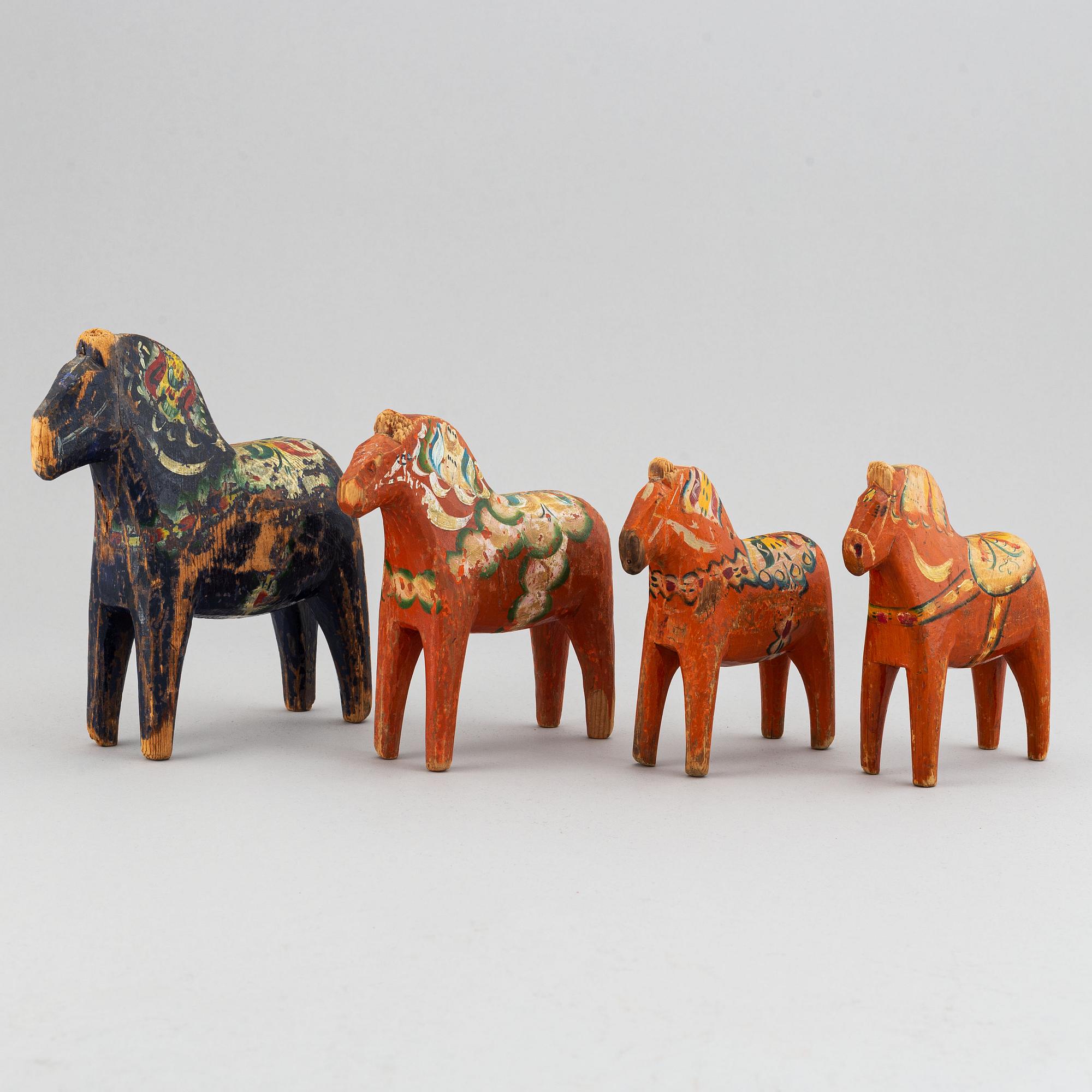 A set of 4 painted wooden horses from the first half of the 20th century.