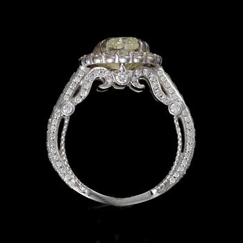 RING, 18K vitguld, diamant 5,014 ct, briljantslipade  diamanter totalt ca 0,90 ct. Vikt ca 8 g.