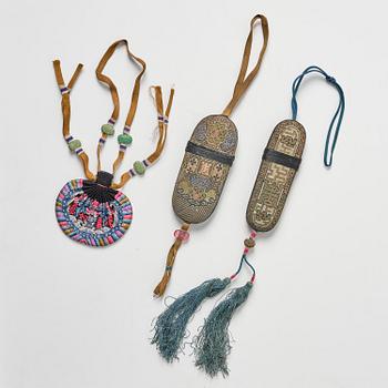 A set of three embroidered purses/ eye-glass cases, Qing dynasty, 19th century.
