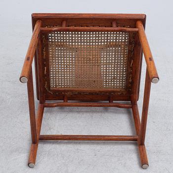A Chinese hardwood dinner table and ten chairs with rattan seats, 20th century.