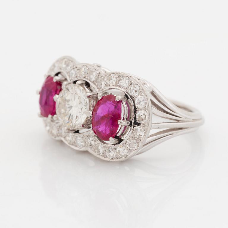 An 18K white gold ring set with faceted rubies and a round brilliant-cut diamond and eight-cut diamonds.