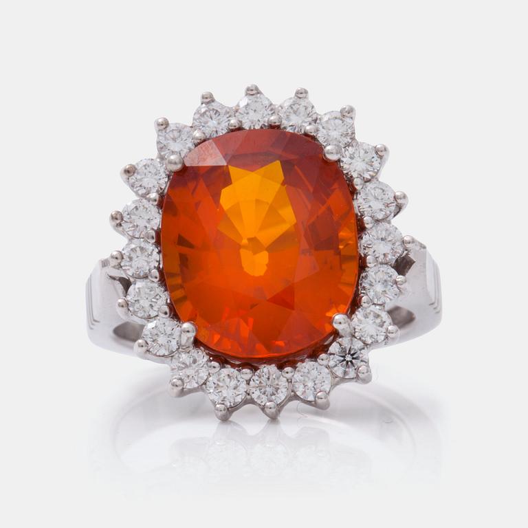 A circa 7.50 ct fancy orange sapphire and brilliant-cut diamond ring.