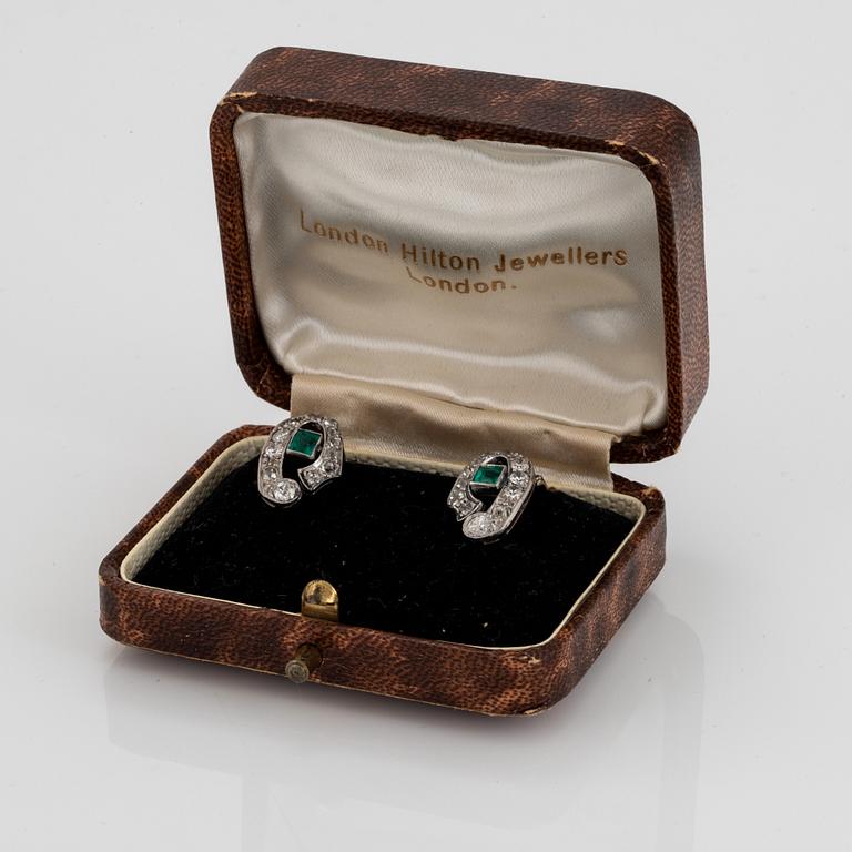 A pair of 18K white gold earrings set with faceted emeralds and old- and eight-cut diamonds.