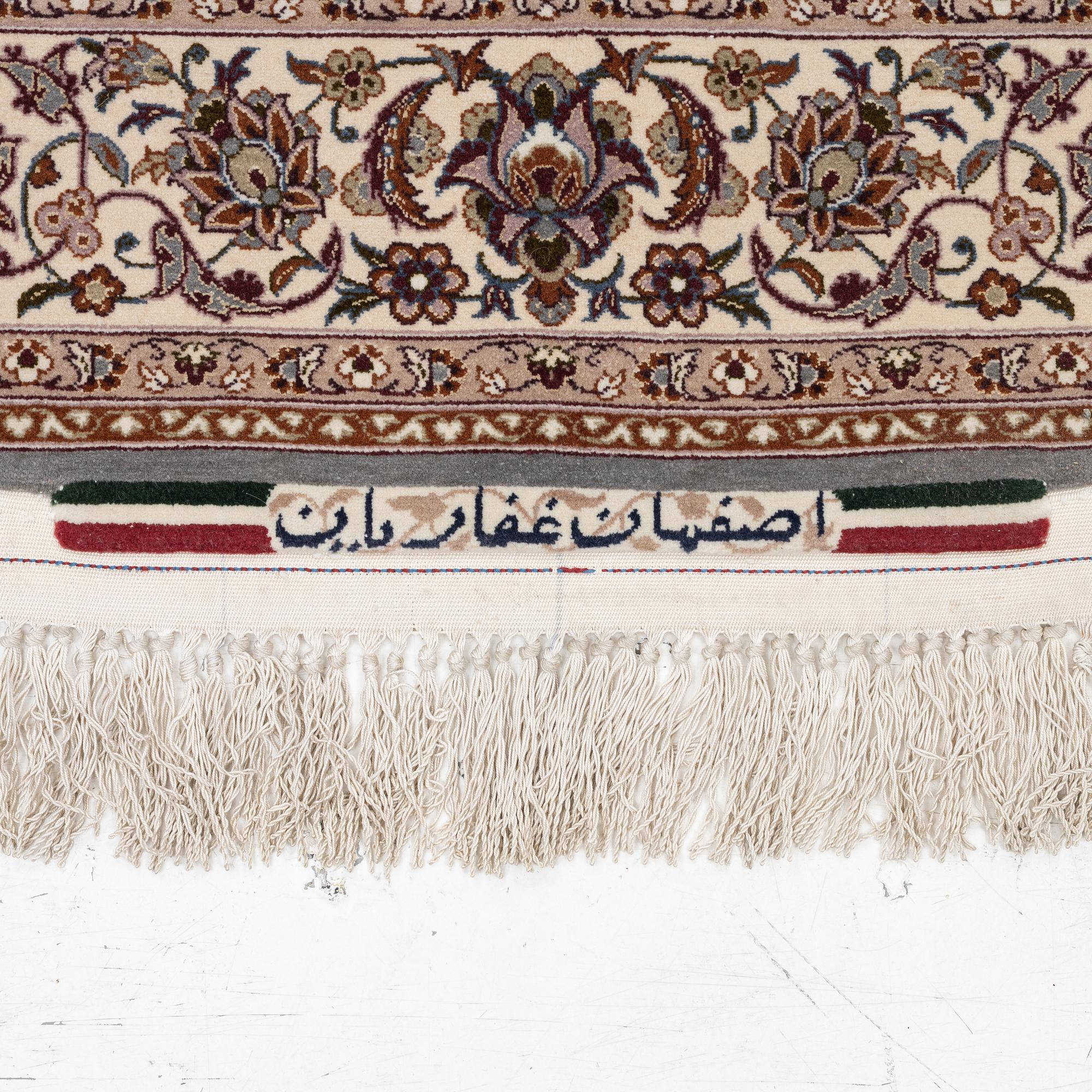 A semi-antique Isfahan rug, central Persia, signed Ghaffarian, c. 180 x 112 cm.