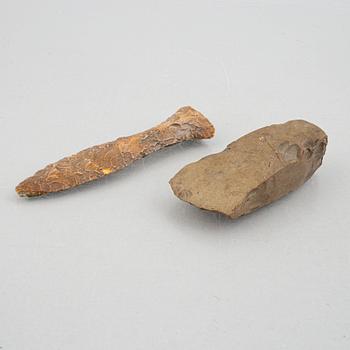 A neolithic flint dagger and an axe.