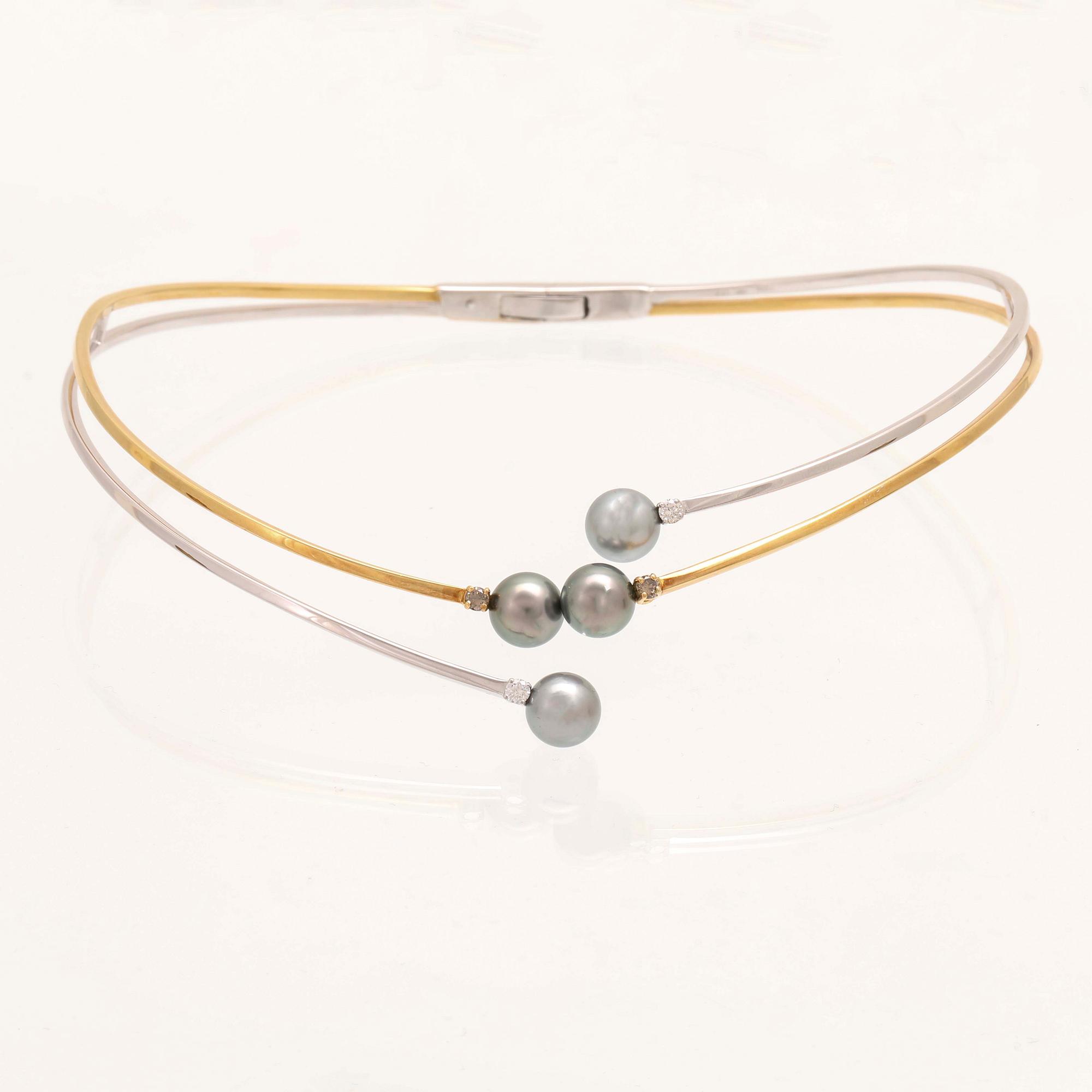An 18K white- and yellow gold necklace with round brilliant cut diamonds and cultured Tahitian pearls, Damiani Italy.
