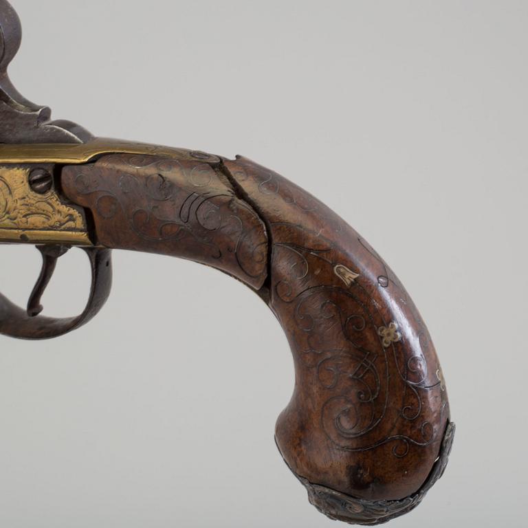 A secon half of the 19th century pair of Queen Anne brass percussion pistols converted from flintlock by Brueton, London.