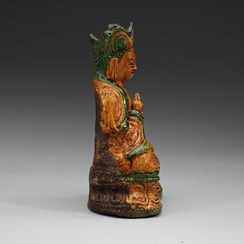 A yellow and green glazed pottery figure of a seated Buddha, Ming dynasty, 17th century.