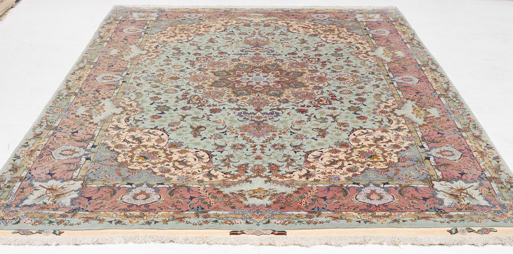 A Tabriz carpet, part silk, approx. 367 x 250 cm.