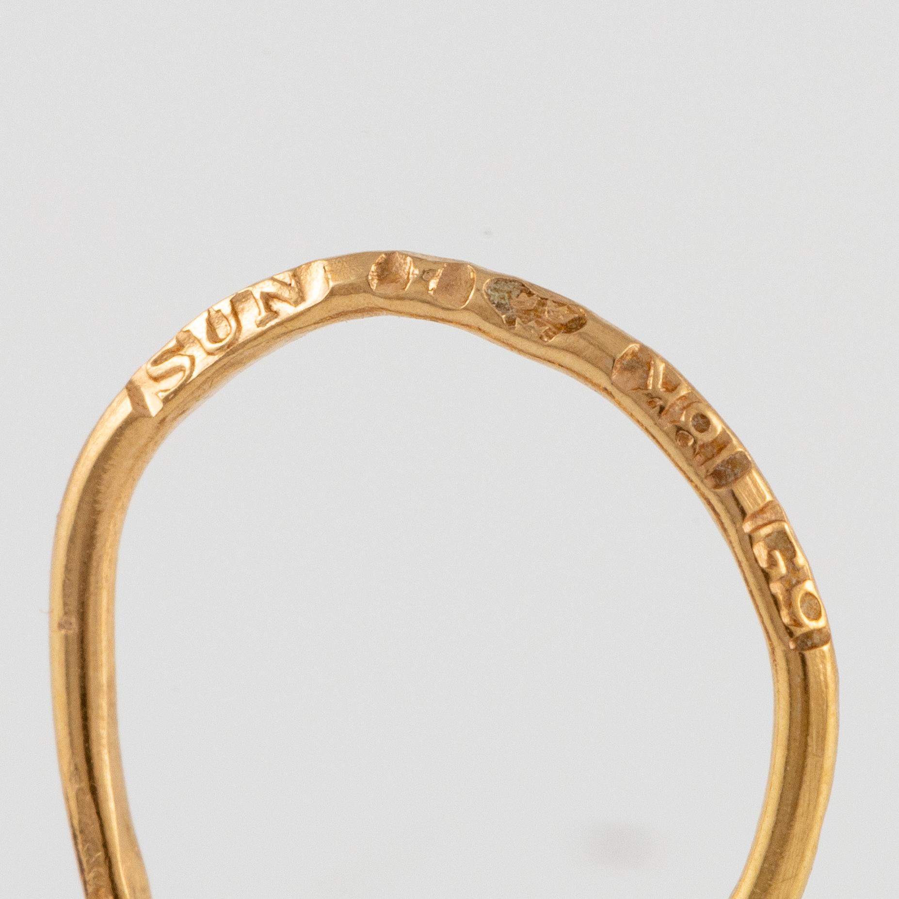 A pair of earrings in 18K gold with purple stones.