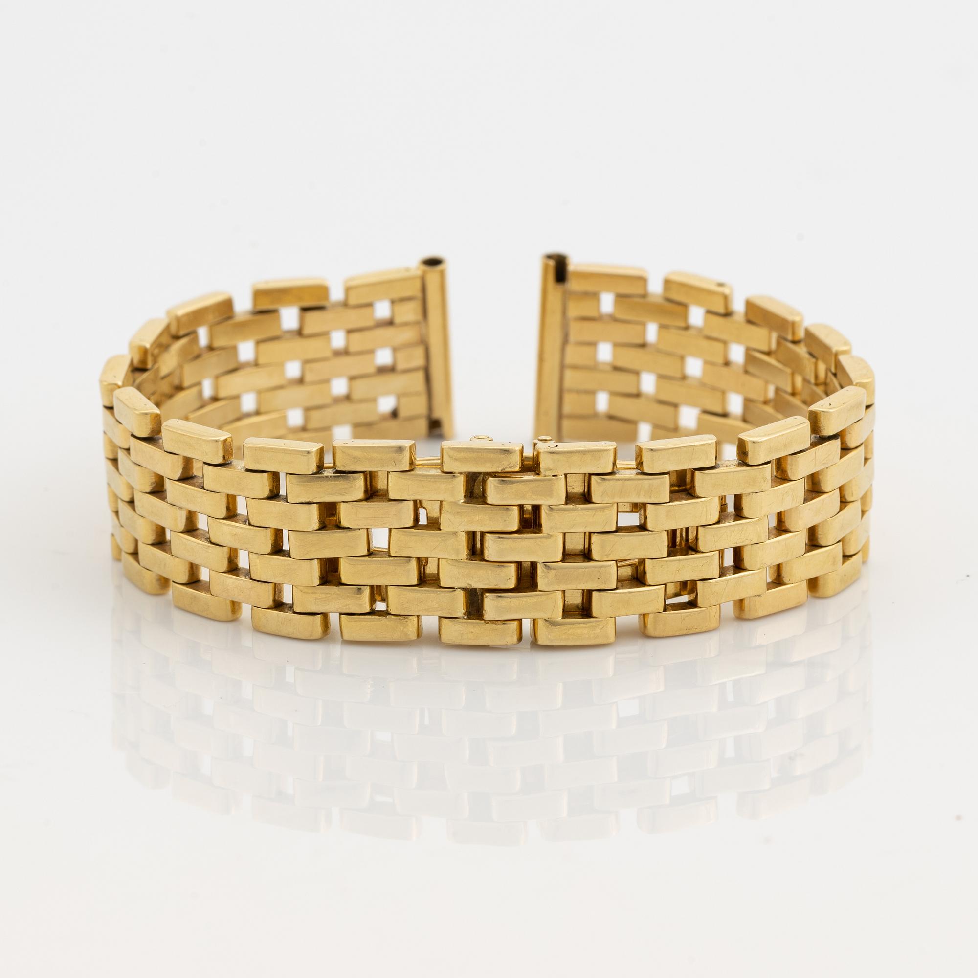 An 18K gold watch bracelet.