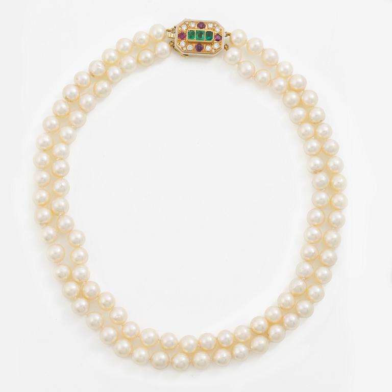 Pearl necklace, two-stranded, with a clasp by Seblings in 18K gold set with emeralds, rubies, and brilliant-cut diamonds.
