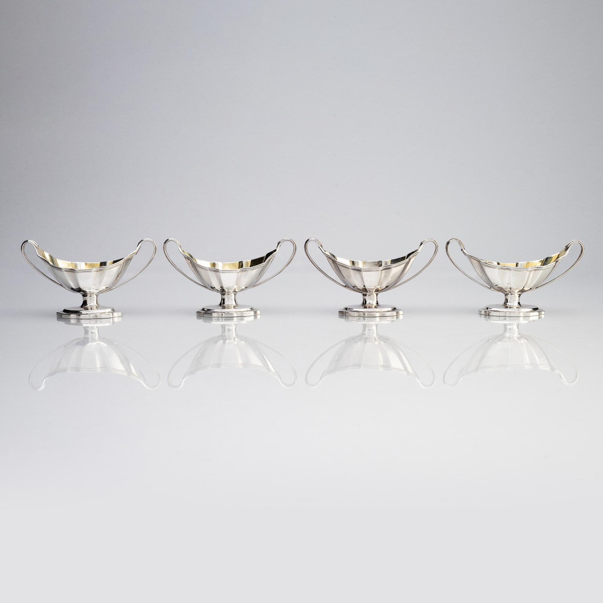 Four English 18th century silver salt-cellars, mark of William Fountain & Daniel Pontifax, London 1791, and spoons.