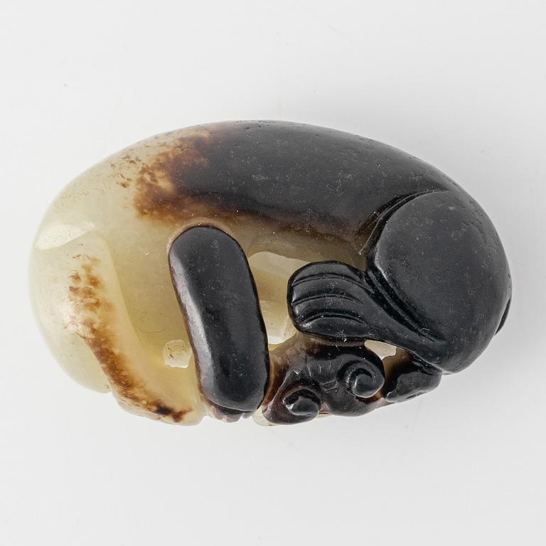 A Chinese nephrite sculpture of a reclining dog, 20th Century.